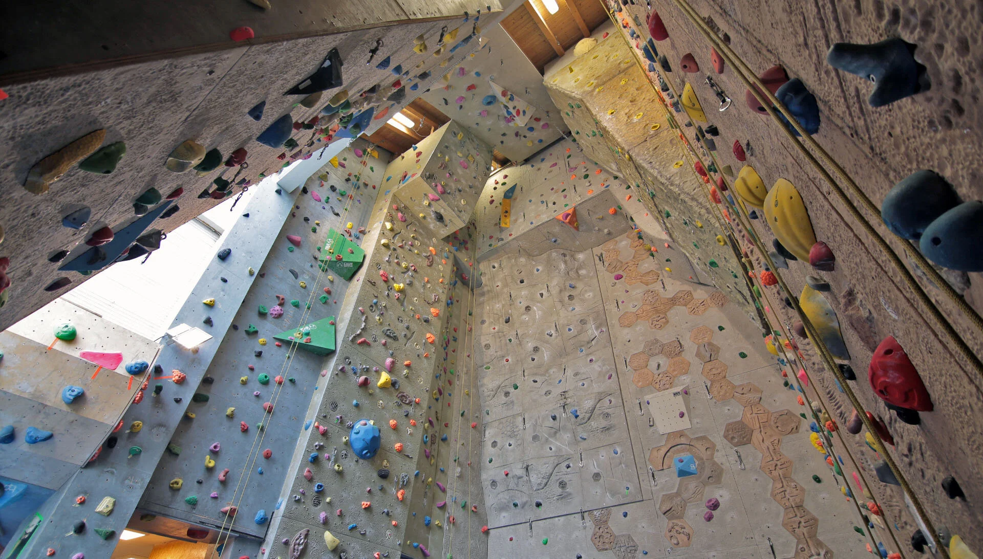 Panoramaaufnahme der Kletterwände mit bunten Griffen in der alten Kletterstube | © DAV Sektion Hohenstaufen Göppingen / Kletterstube